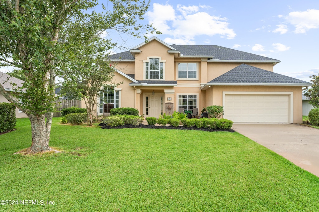 view of front of house featuring a garage and a front yard