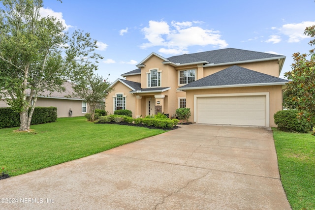 view of front of house with a front lawn and a garage