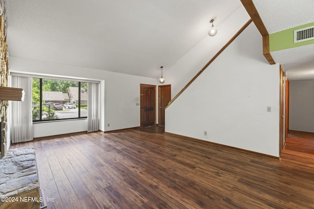 unfurnished living room featuring dark wood-type flooring, a fireplace, and high vaulted ceiling