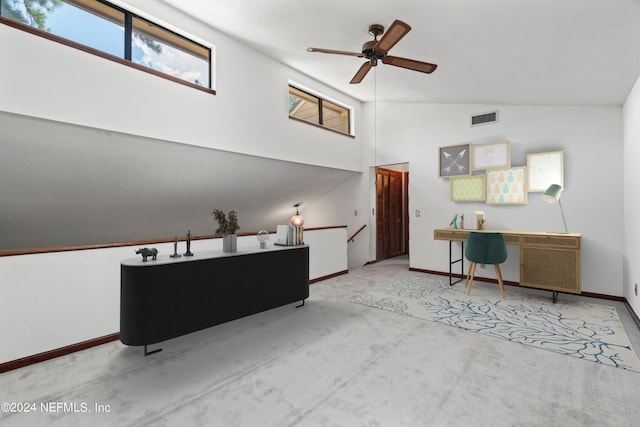 carpeted home office featuring ceiling fan, a healthy amount of sunlight, and high vaulted ceiling