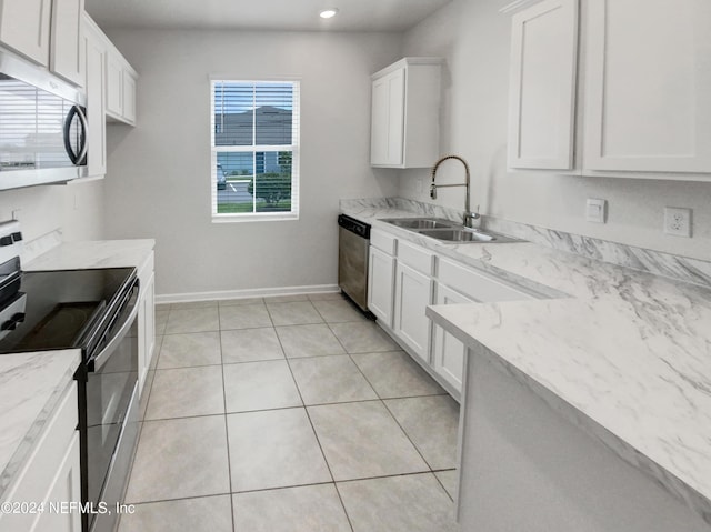 kitchen with white cabinets, stainless steel appliances, light stone countertops, and sink