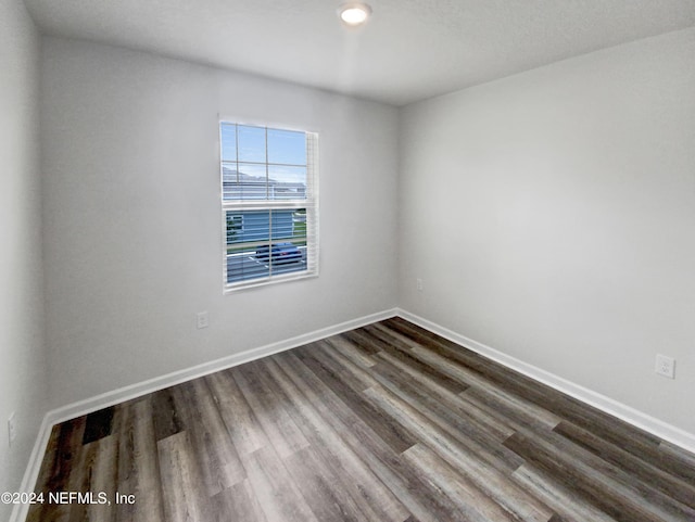 empty room featuring dark hardwood / wood-style flooring