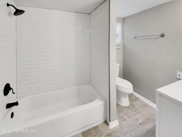 full bathroom featuring toilet, vanity, and tiled shower / bath combo