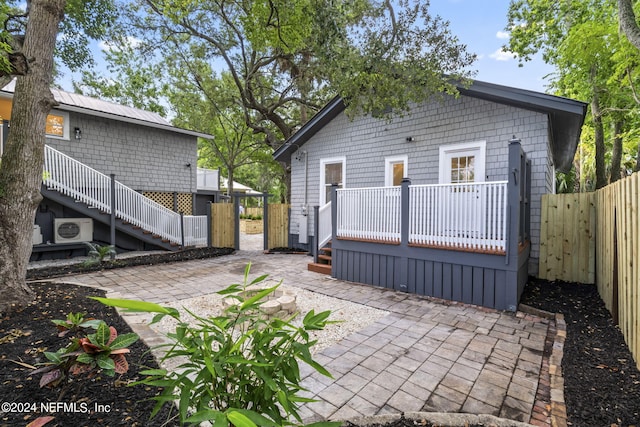 back of house featuring stairs, a patio, ac unit, and a fenced backyard