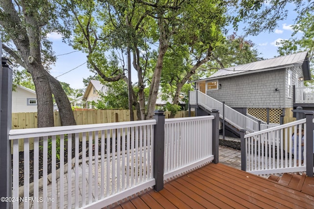 deck featuring stairs and fence