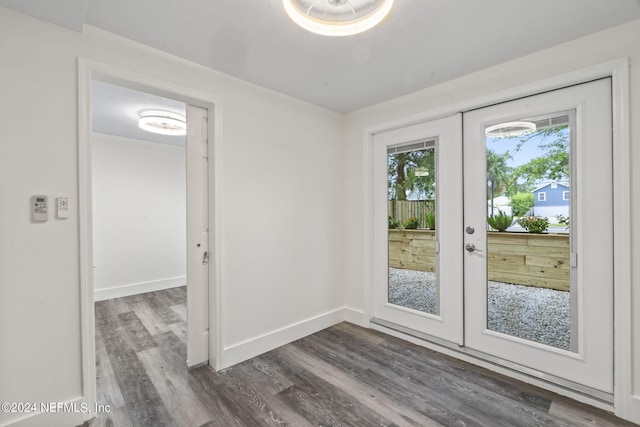 entryway featuring dark wood-style flooring, baseboards, and french doors