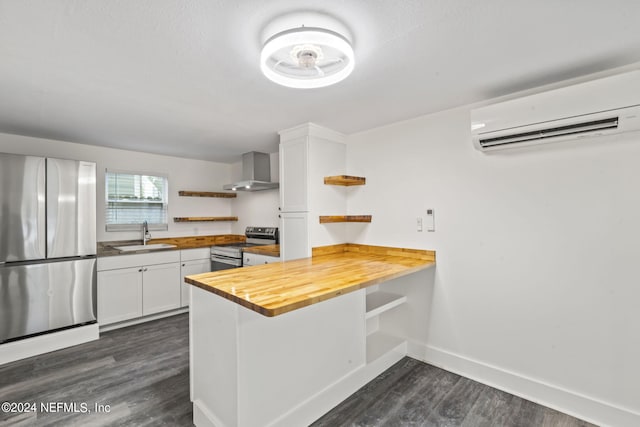 kitchen featuring butcher block counters, a wall mounted air conditioner, stainless steel appliances, white cabinetry, and open shelves