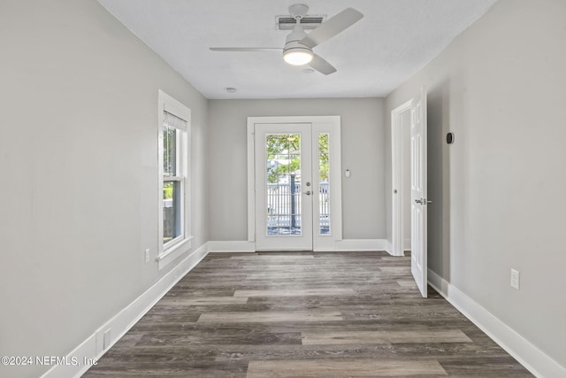 entrance foyer with a ceiling fan, dark wood-style flooring, visible vents, and baseboards