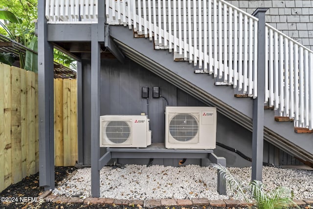 exterior details featuring ac unit and fence