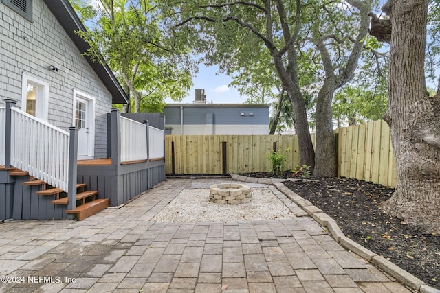 view of patio with a fire pit and a fenced backyard