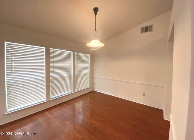 unfurnished dining area with dark hardwood / wood-style flooring and lofted ceiling