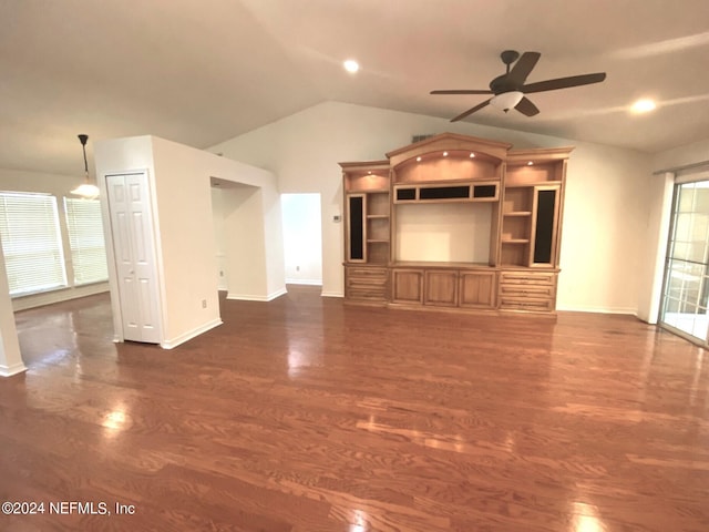 unfurnished living room featuring ceiling fan, dark hardwood / wood-style flooring, and vaulted ceiling