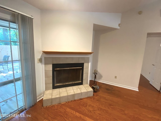 room details featuring hardwood / wood-style flooring and a tiled fireplace