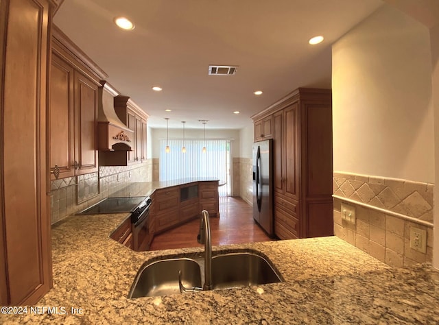 kitchen with stainless steel fridge, custom range hood, electric stove, sink, and pendant lighting