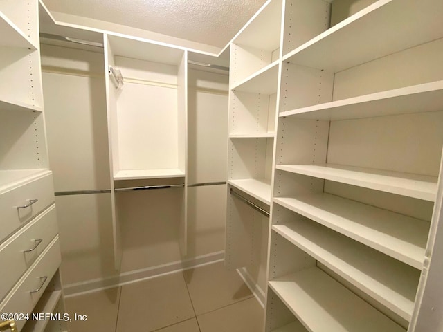 spacious closet with tile patterned flooring