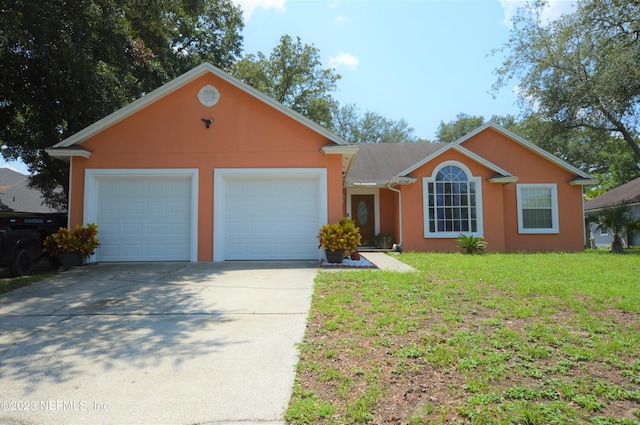 ranch-style home featuring a front lawn and a garage