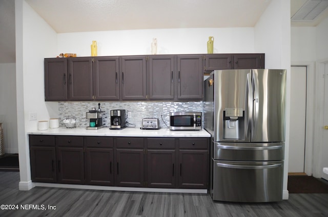 kitchen with dark brown cabinetry, decorative backsplash, dark hardwood / wood-style floors, and appliances with stainless steel finishes