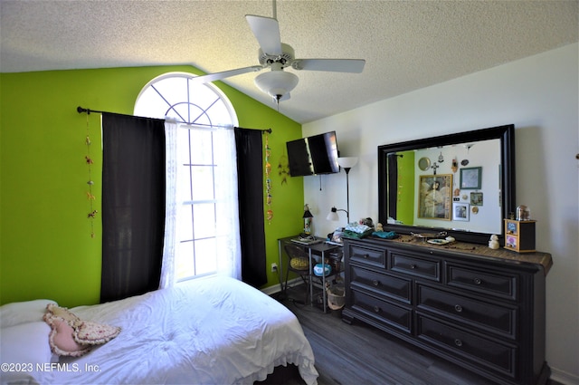 bedroom with ceiling fan, dark hardwood / wood-style flooring, a textured ceiling, and vaulted ceiling