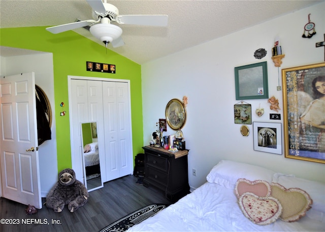 bedroom featuring vaulted ceiling, ceiling fan, a textured ceiling, dark hardwood / wood-style flooring, and a closet