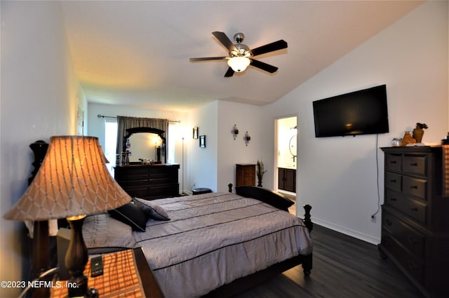 bedroom featuring ceiling fan, dark hardwood / wood-style flooring, connected bathroom, and vaulted ceiling