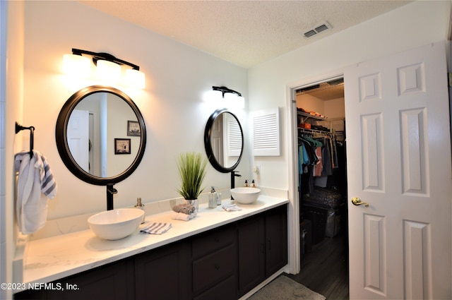 bathroom featuring vanity, a textured ceiling, and hardwood / wood-style flooring