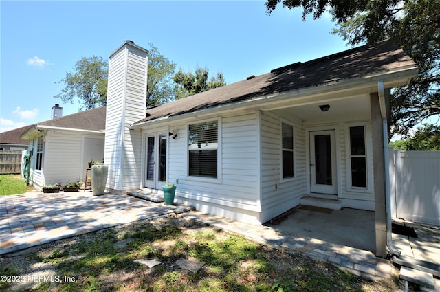 view of front of home with french doors and a patio area