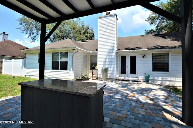 view of patio featuring an outdoor bar and french doors