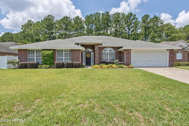 single story home with a garage and a front lawn