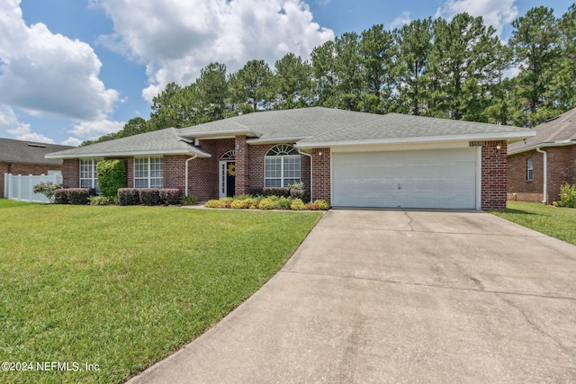 ranch-style house featuring a garage and a front yard