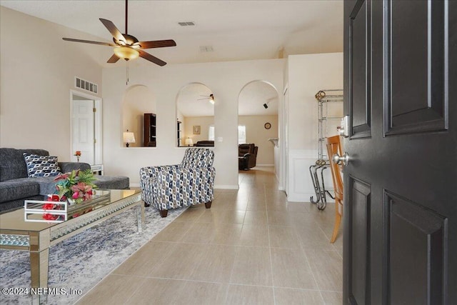 tiled living room with ceiling fan