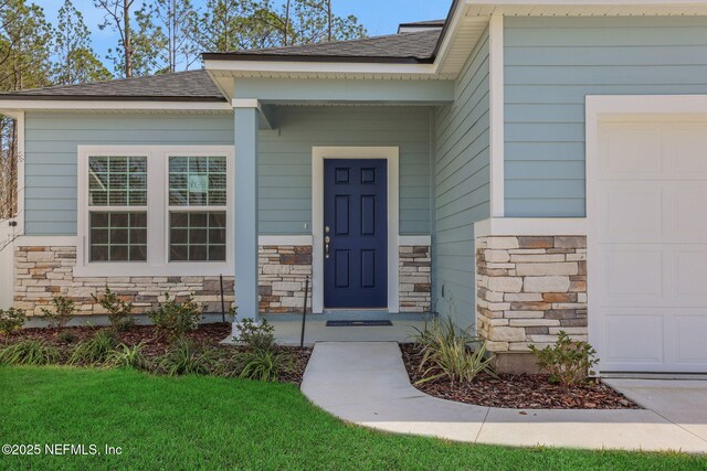 doorway to property with a garage