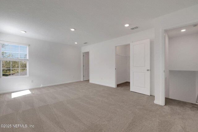 carpeted spare room with a textured ceiling