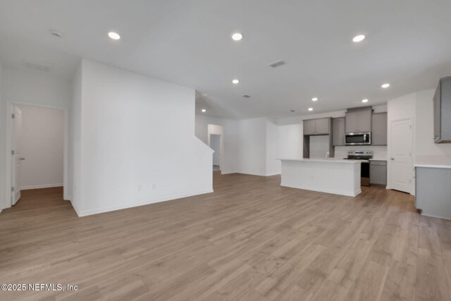 unfurnished living room featuring light hardwood / wood-style flooring