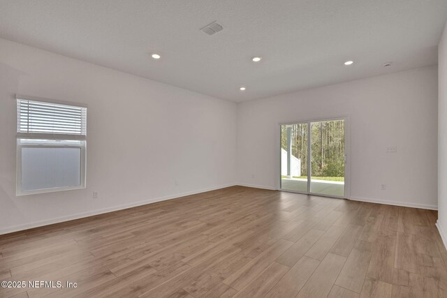 spare room with light wood-type flooring