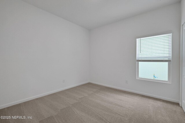 empty room featuring light colored carpet