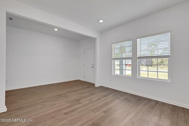 spare room featuring light hardwood / wood-style floors