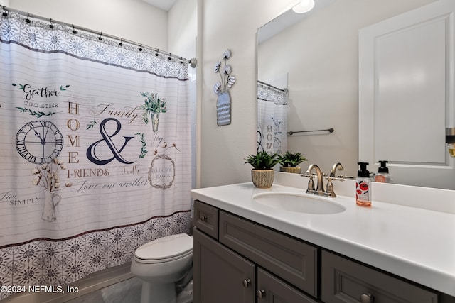 bathroom featuring toilet and vanity