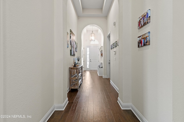 corridor with dark hardwood / wood-style flooring