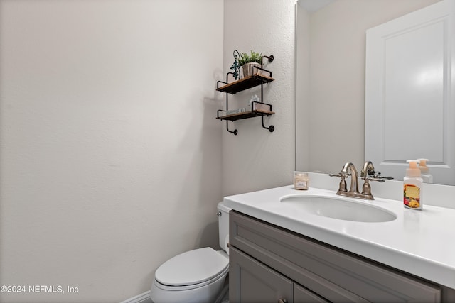 bathroom with toilet and vanity