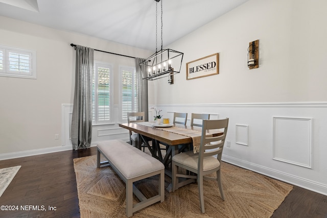 dining area with a notable chandelier and hardwood / wood-style floors