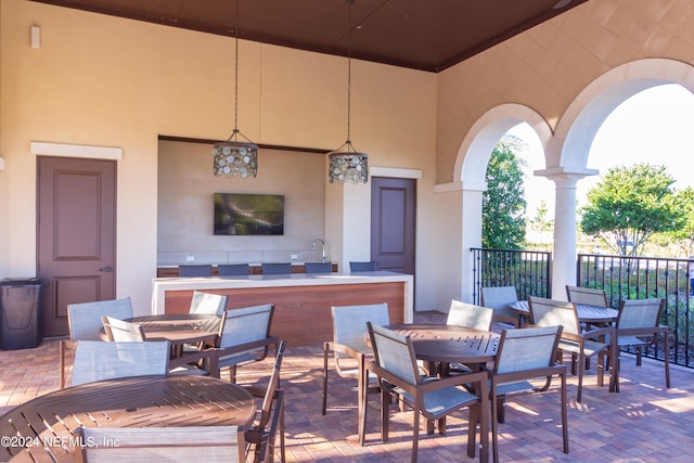 view of patio / terrace featuring a tile fireplace and sink