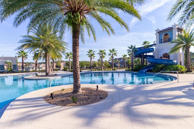 view of pool with a water slide