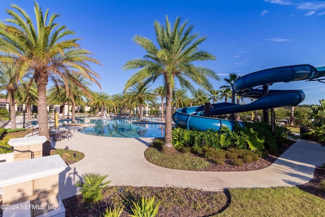 view of pool featuring a patio and a water slide