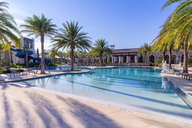 view of pool featuring a patio and a water slide