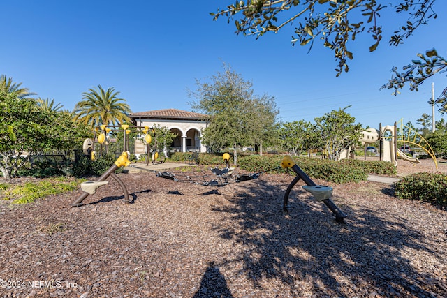 back of property with a playground