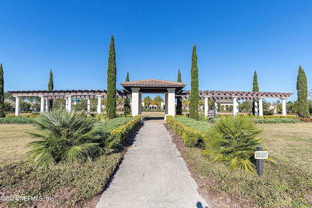 surrounding community featuring a lawn and a pergola