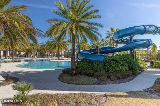 view of swimming pool featuring a water slide