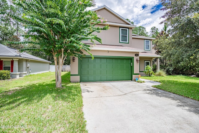 view of front property featuring a garage and a front yard