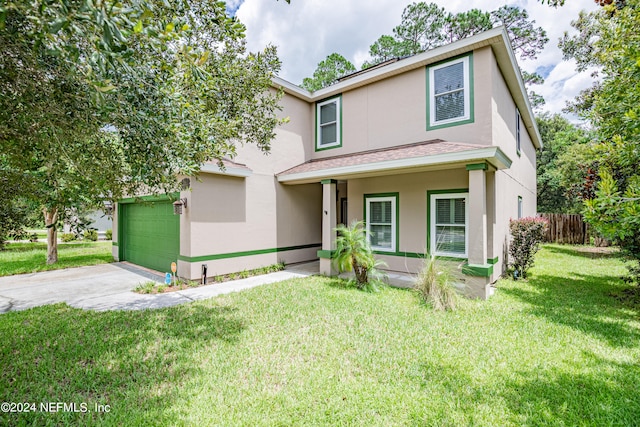 view of property with a garage and a front yard