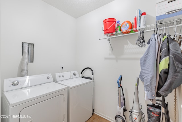 laundry area featuring a textured ceiling and separate washer and dryer